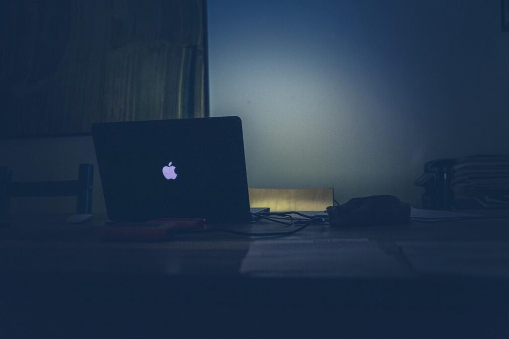 A dimly lit desk at 2 a.m. with a glowing laptop and a stack of papers, capturing the eerie atmosphere of late-night academic writing and AI drafting.