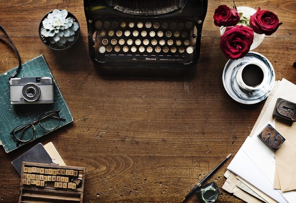 Vintage manual typewriter on a minimalist writer’s desk next to a ceramic coffee mug and open leather journals, representing human-led creativity in an AI writing workflow.
