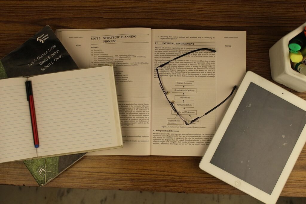 Academic writing workflow with printed sources annotations and digital editing tools.