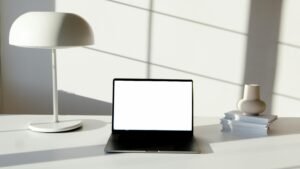 Minimalist workspace with a laptop on a clean white desk, used as the featured image for an AWeber review.