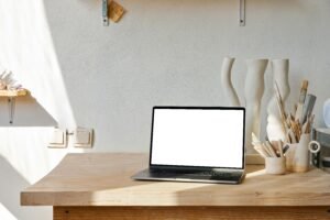 Bright minimalist researcher desk with a laptop and creative tools, illustrating an AI writing workflow.