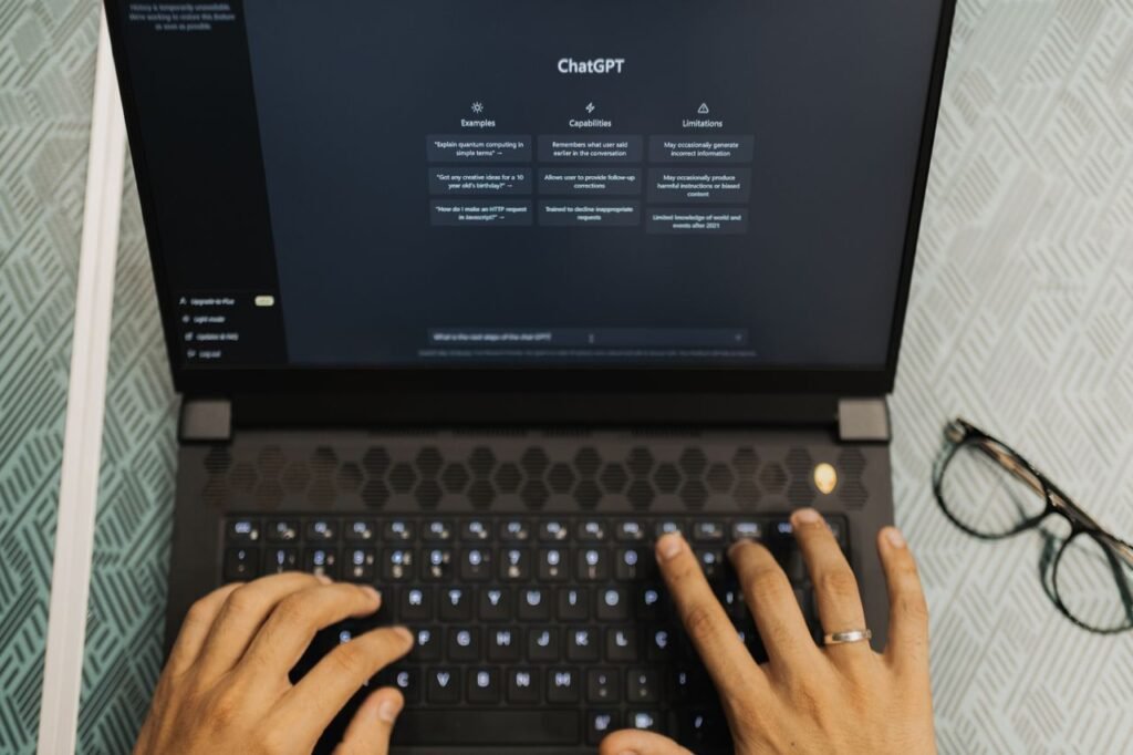 A researcher using ChatGPT on a laptop to write and research a PhD thesis.