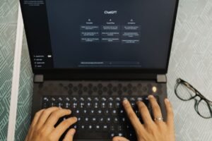 A researcher using ChatGPT on a laptop to write and research a PhD thesis.