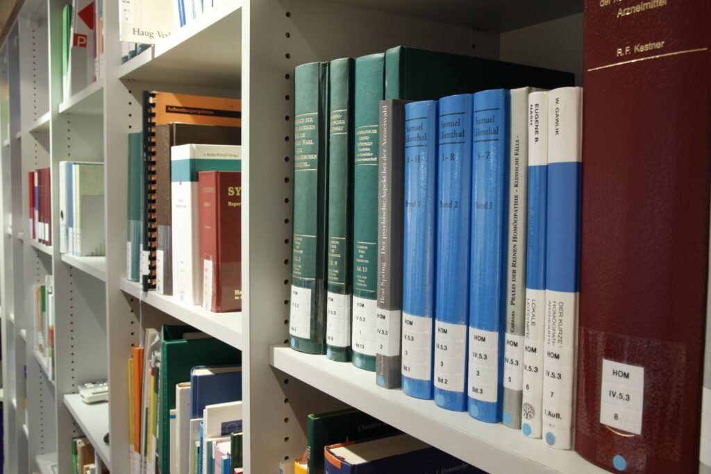 Academic books on a library shelf representing traditional research and scholarly writing.